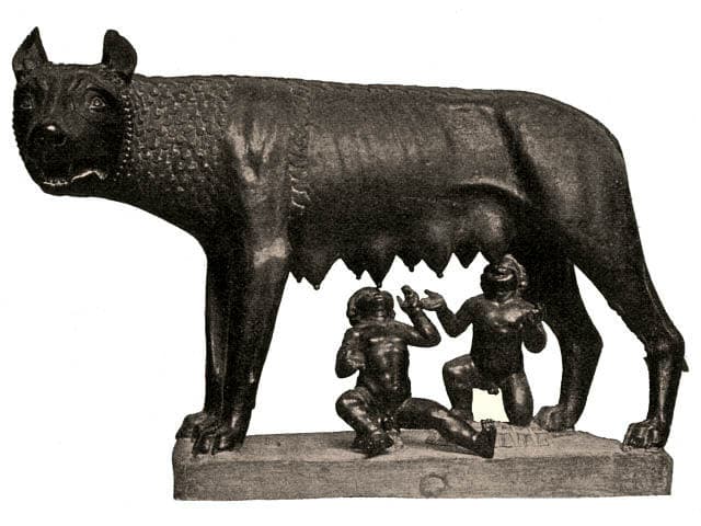 Bronze statue of a she-wolf standing over two small human infants reaching up to suckle beneath her.