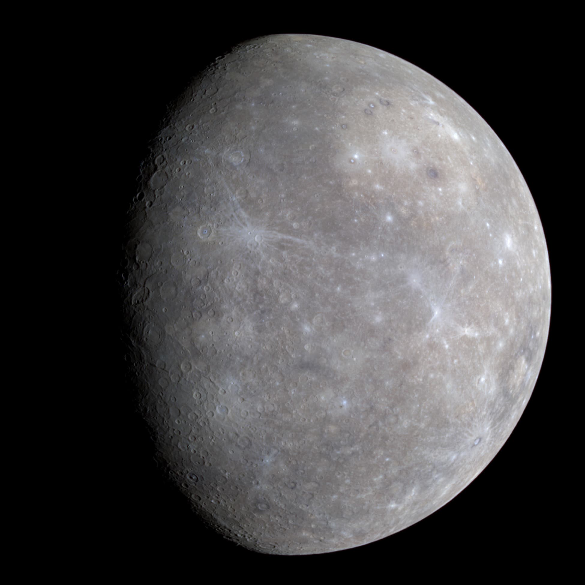 A full-disc color photo of Mercury, a cratered, tan-and-gray world similar in appearance to Earth's Moon.