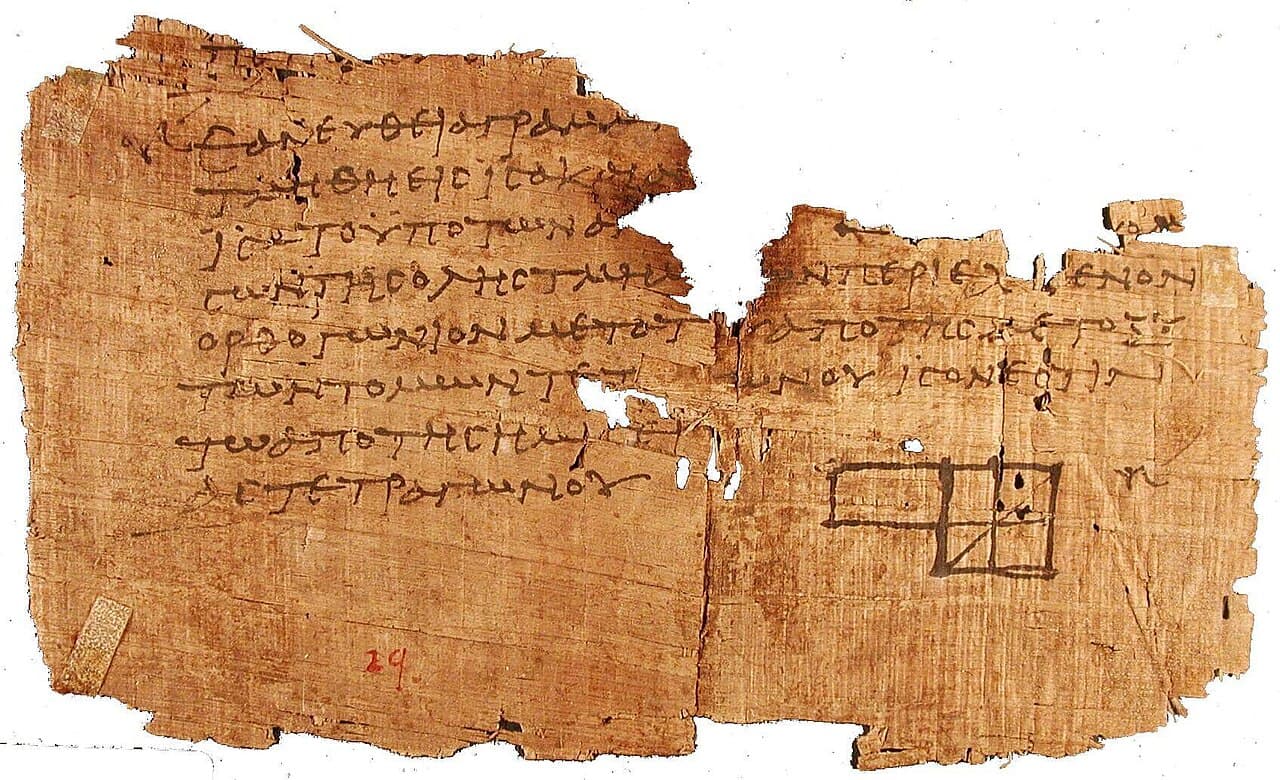 A torn, brownish papyrus fragment covered in Greek writing, with a small geometric diagram.